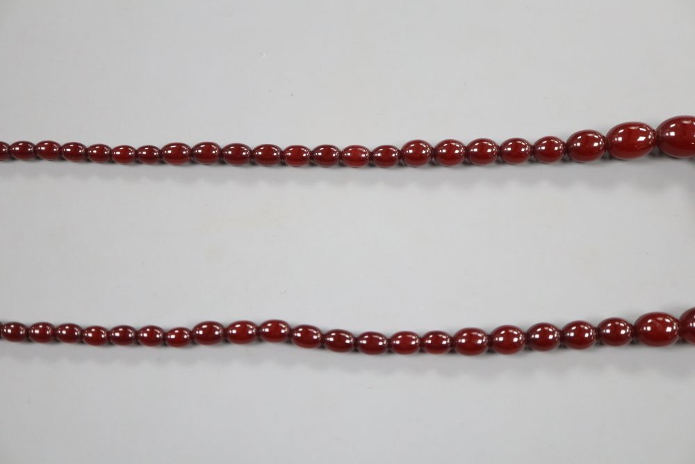 A single strand graduated simulated cherry amber oval bead necklace, 69cm, gross 54 grams.
